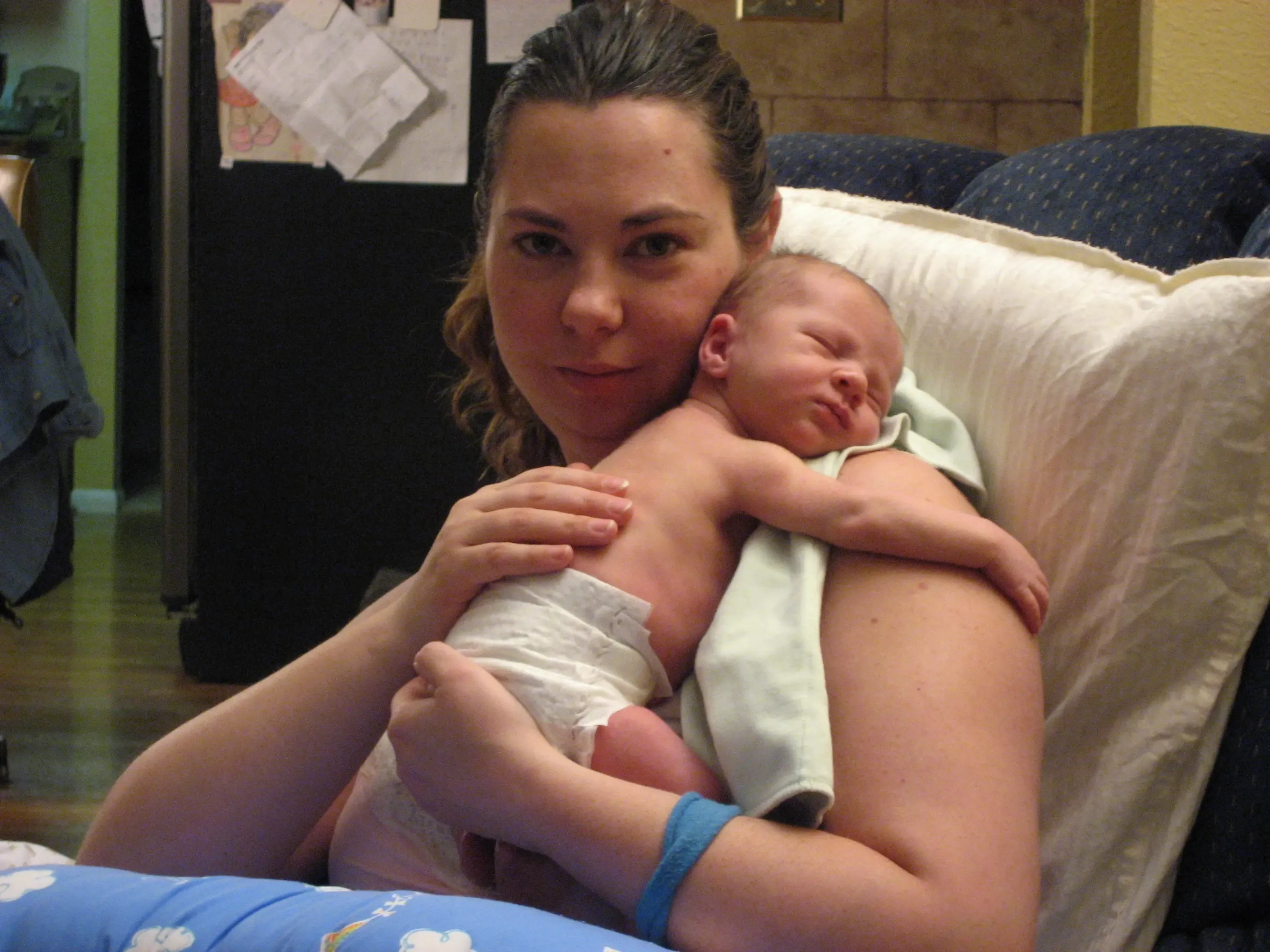 Kristi holding a newborn baby on her chest